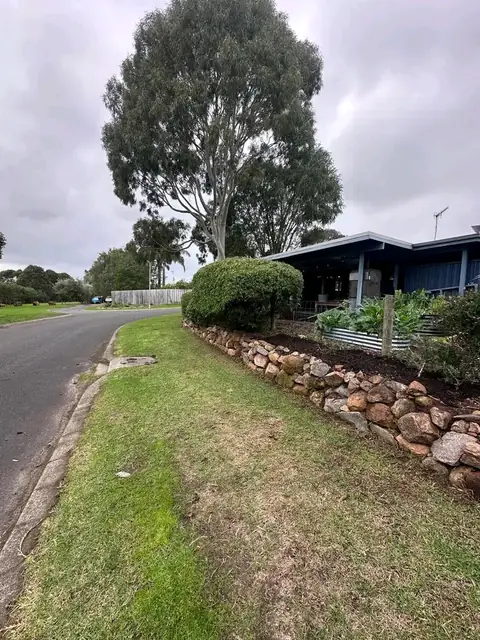 Trimmed hedges and rock wall along a Margaret River street (3 of 9)